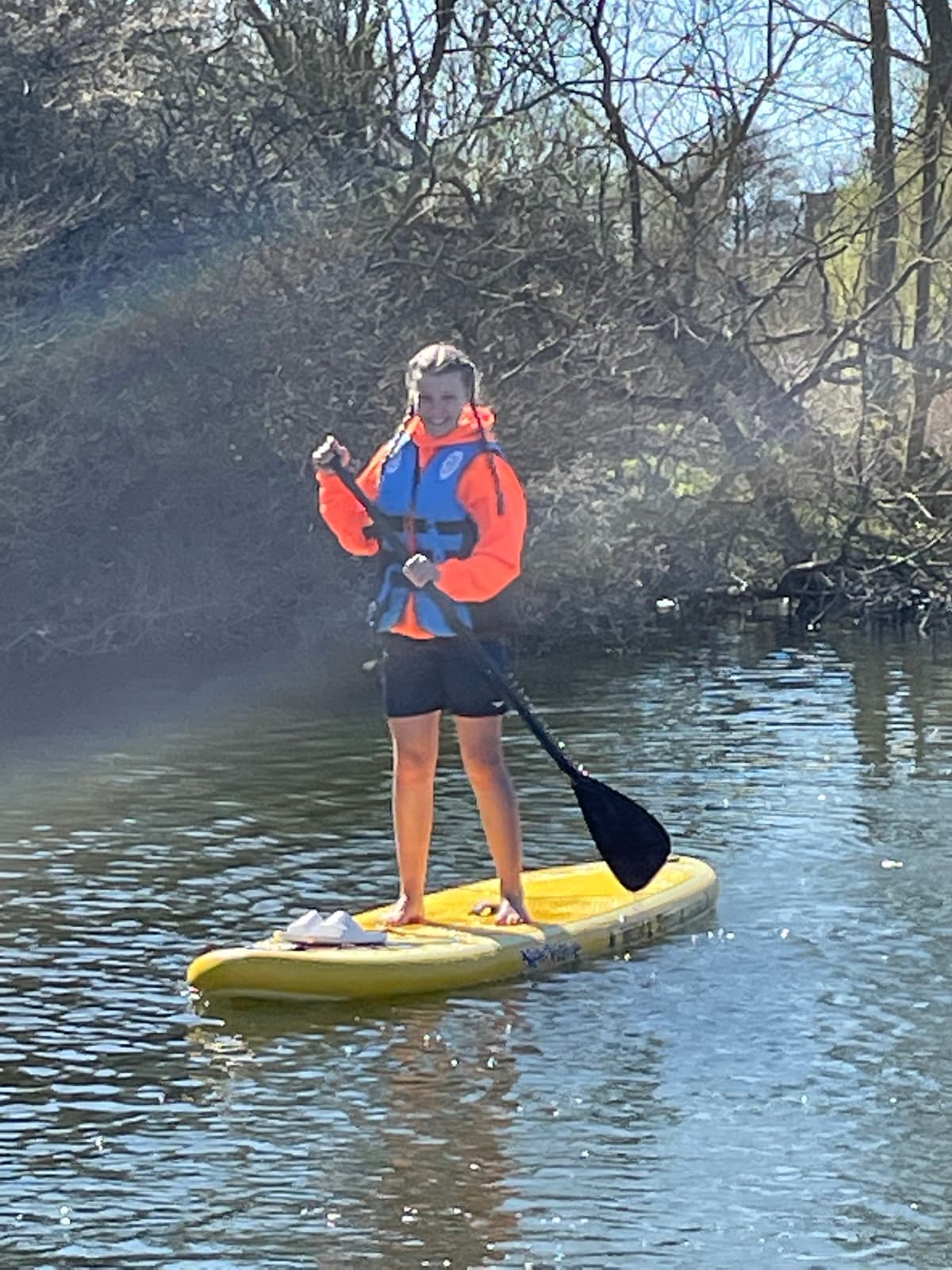 Paddler standing tall on a yellow NewWave board